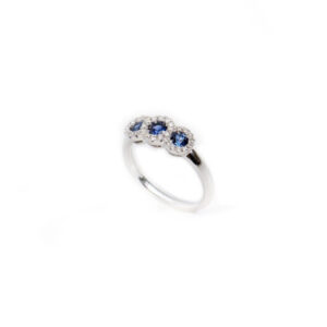 three sapphires with diamond halo set in white gold